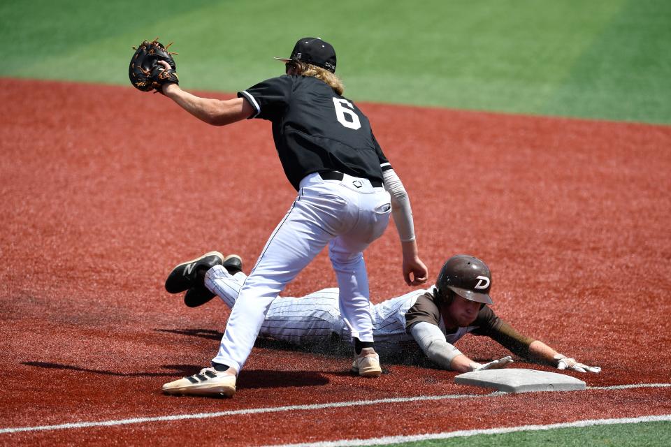 DeSales' Alex Yurt (9) dives back to first ahead of the pickoff throw to Fern Creek's Carson Allen (6) during their Sixth Region semifinal baseball game, Saturday, May 28 2022 in Louisville Ky. DeSales defeated Fern Creek 1-0 and will advance to the region championship game.