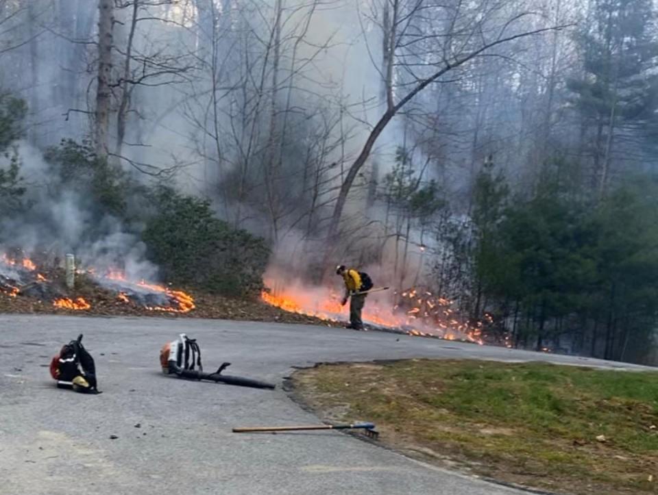 A Saluda Fire & Rescue firefighter works to contain a brush fire in Saluda on April 1.