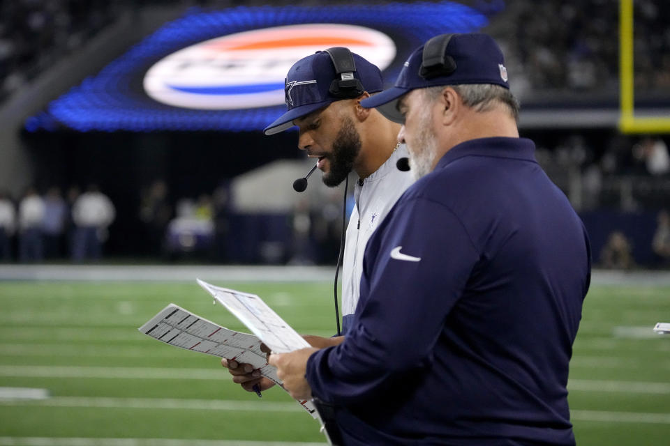 Dallas Cowboys quarterback Dak Prescott calls plays as head coach Mike McCarthy, right, stands by on the sideline in the first half of a preseason NFL football game against the Las Vegas Raiders in Arlington, Texas, Saturday, Aug. 26, 2023. (AP Photo/Sam Hodde)