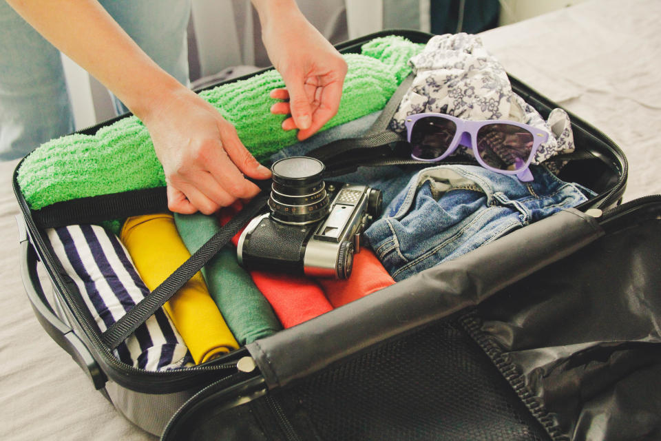 person packing a suitcase