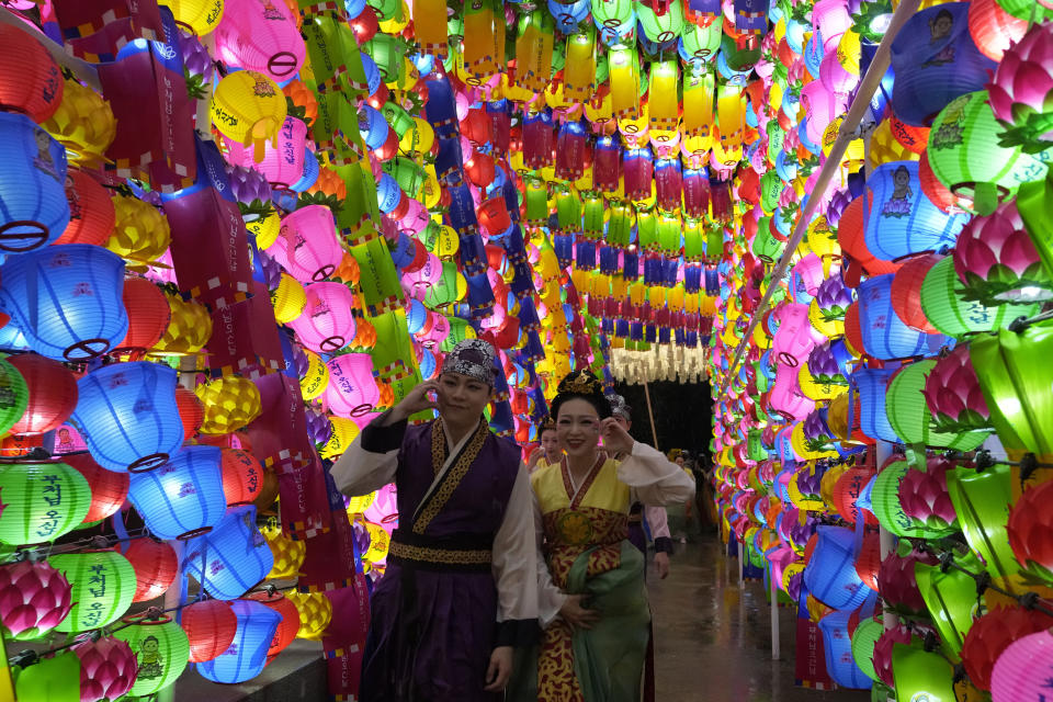 Buddhists walk past lanterns during the Lotus Lantern Festival, ahead of the birthday of Buddha in Seoul, South Korea, Saturday, May 11, 2024. (AP Photo/Ahn Young-joon)