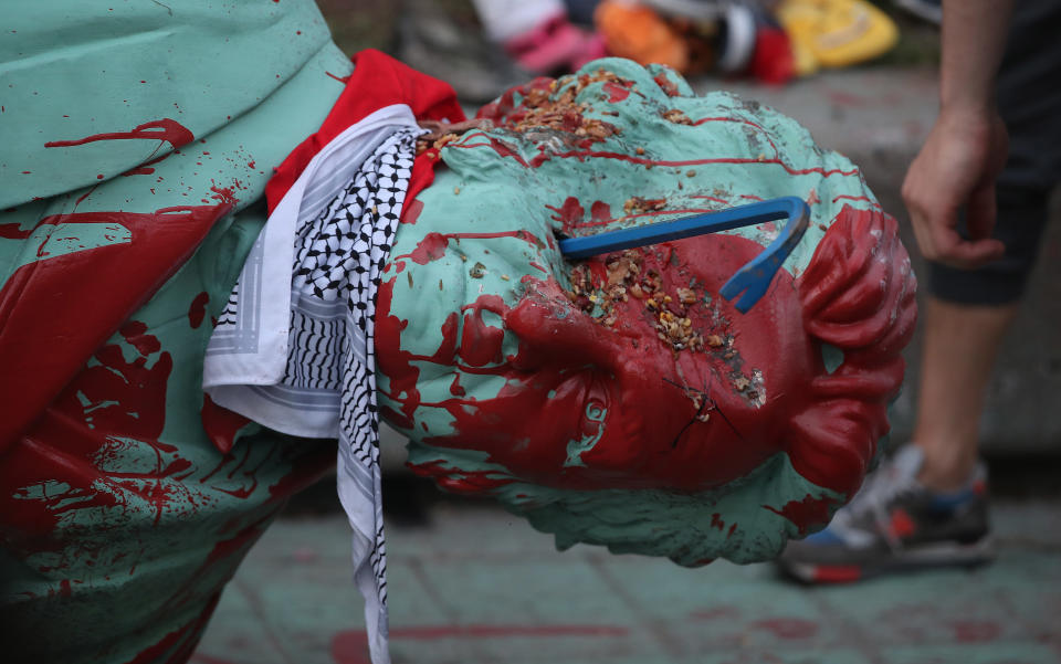 <p>The toppled statue of Egerton Ryerson, one of the architects of indigenous boarding school system, is laying on its side in Toronto on June 6, 2021. (Steve Russell/Toronto Star via Getty Images)</p> 