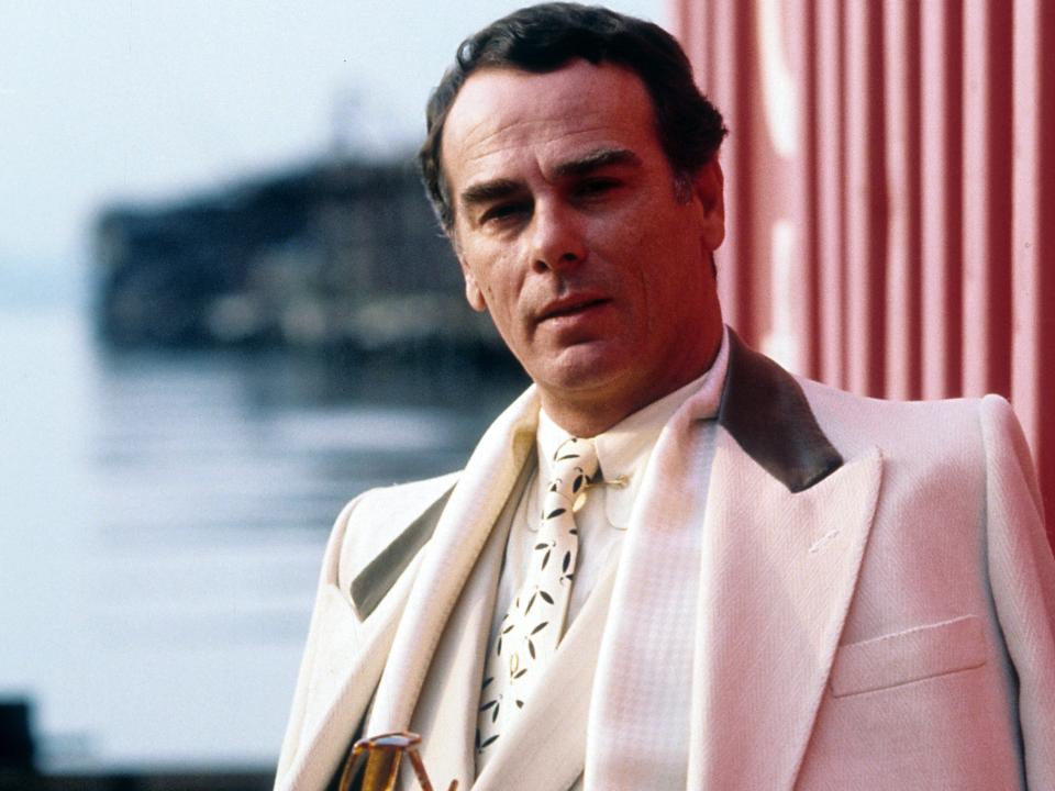 Dean Stockwell holding sunglasses