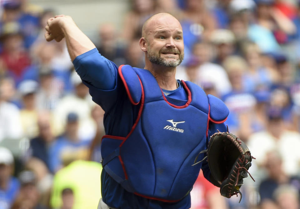FILE - In this July 24, 2016, file photo, Chicago Cubs' David Ross throws out a Milwaukee Brewers batter during a baseball game in Milwaukee. Former Cubs catchers Joe Girardi and Ross will speak with the team next week about its managerial opening. The team also plans to interview first base coach Will Venable next week. Bench coach Mark Loretta interviewed for the job Thursday. The Cubs are searching for a successor to Joe Maddon, whose contract expired after the Cubs missed the playoffs this year for the first time since 2014. (AP Photo/Benny Sieu, File)