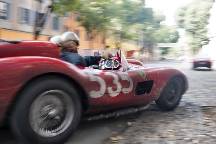 a person driving a red ferrari