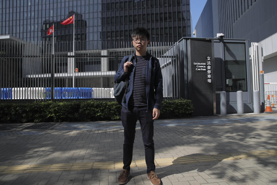 Pro-democracy activist Joshua Wong stands outside the Legislative Council building in Hong Kong, Thursday, Nov. 28, 2019. Police teams on Thursday began clearing a Hong Kong university that was a flashpoint for clashes with anti-government demonstrators, as the government slammed a U.S. move to sign into law bills supporting human rights in the Chinese territory. (AP Photo/Kin Cheung)