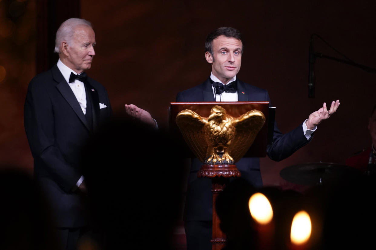 President Joe Biden listens as French President Emmanuel Macron speaks before a toast during a State Dinner on the South Lawn of the White House in Washington, Thursday, Dec. 1, 2022. (AP Photo/Andrew Harnik)