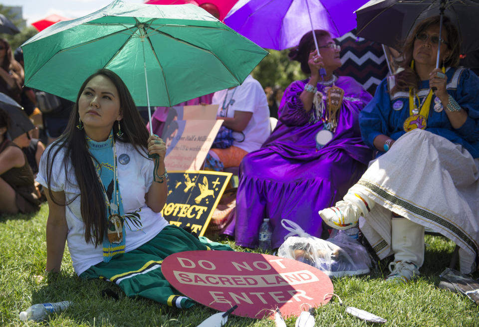 FILE - Native American Indians including Noel Altaha, left, of White Mountain Apache tribe, join Apache Stronghold activists in a rally to save Oak Flat, land near Superior, Ariz., sacred to Western Apache tribes, in front of the U.S. Capitol in Washington, on July 22, 2015. Included in the infrastructure deal that became law last month is $2.5 billion for Native American water rights settlements. The agreements quantify individual tribes' claims to water and identify infrastructure projects to help deliver the water to residents. For many tribes including the White Mountain Apache, the money couldn't come sooner. The $2.5 billion is part of roughly $11 billion headed to tribal lands for other infrastructure needs including broadband coverage, roads and more. (AP Photo/Molly Riley,File)