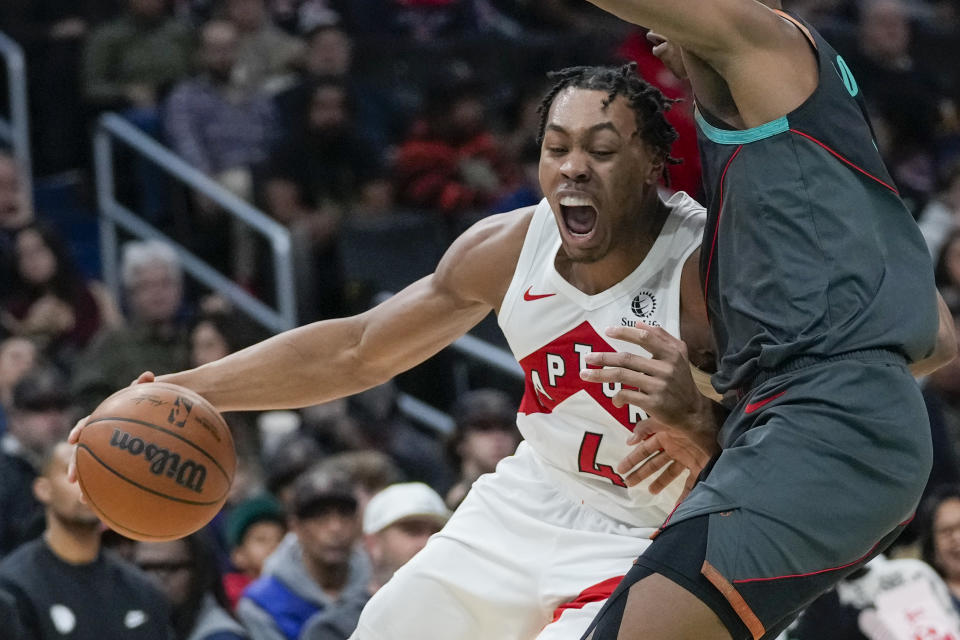 Toronto Raptors forward Scottie Barnes, left, drives against Washington Wizards guard Bilal Coulibaly during the first half of an NBA basketball game Wednesday, Dec. 27, 2023, in Washington. (AP Photo/Alex Brandon)