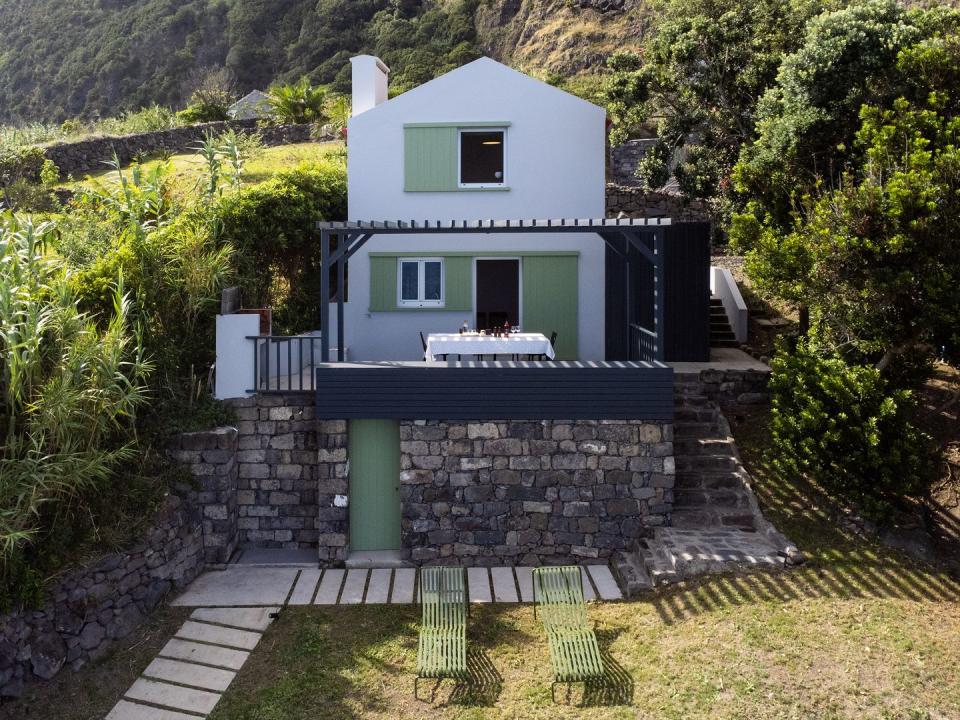 a small house with a stone patio