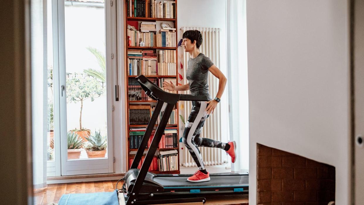 woman training on treadmill at home
