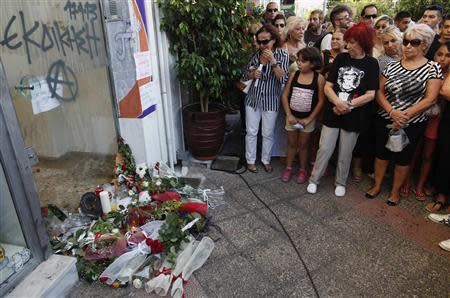 People gather at the site where Pavlos Fissas, a 35-year-old anti-racism rapper was stabbed to death, by a man who sympathized with the far-right Golden Dawn group, at Keratsini suburb southwest of Athens September 18, 2013. REUTERS/John Kolesidis