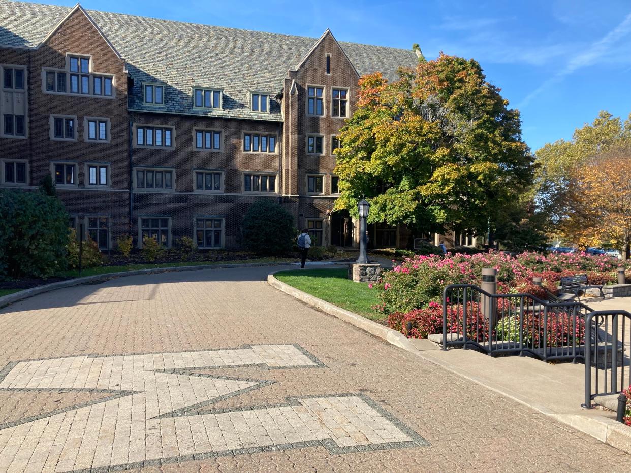 A student walks near the western wing of Old Main on the Mercyhurst University campus in this October 2022 photo.