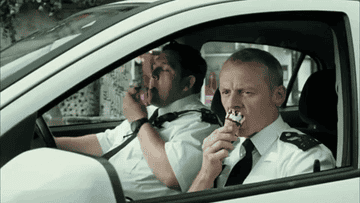 Two cops from "Hot Fuzz" eating ice cream in their car.