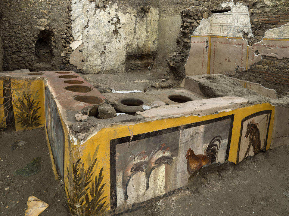 An undated photo made available by the Pompeii Archeological park press office shows the thermopolium in the Pompeii archeological park, near Naples, Italy. A fast-food eatery discovered at Pompeii is now completely excavated, helping to reveal some favorite dishes of citizens of the ancient Roman city who liked to eat out. Pompeii Archaeological Park’s longtime chief, Massimo Osanna said Saturday, Dec. 26, 2020, in a statement that while some 80 such fast-foods have been found at Pompeii, it is the first time such an eatery — known as a thermopolium since it serve hot foods — had been entirely excavated. (Luigi Spina/Parco Archeologico di Pompei via AP)