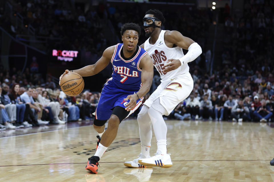 Philadelphia 76ers guard Kyle Lowry (7) drives against Cleveland Cavaliers guard Donovan Mitchell (45) during the first half of an NBA basketball game Friday, March 29, 2024, in Cleveland. (AP Photo/Ron Schwane)