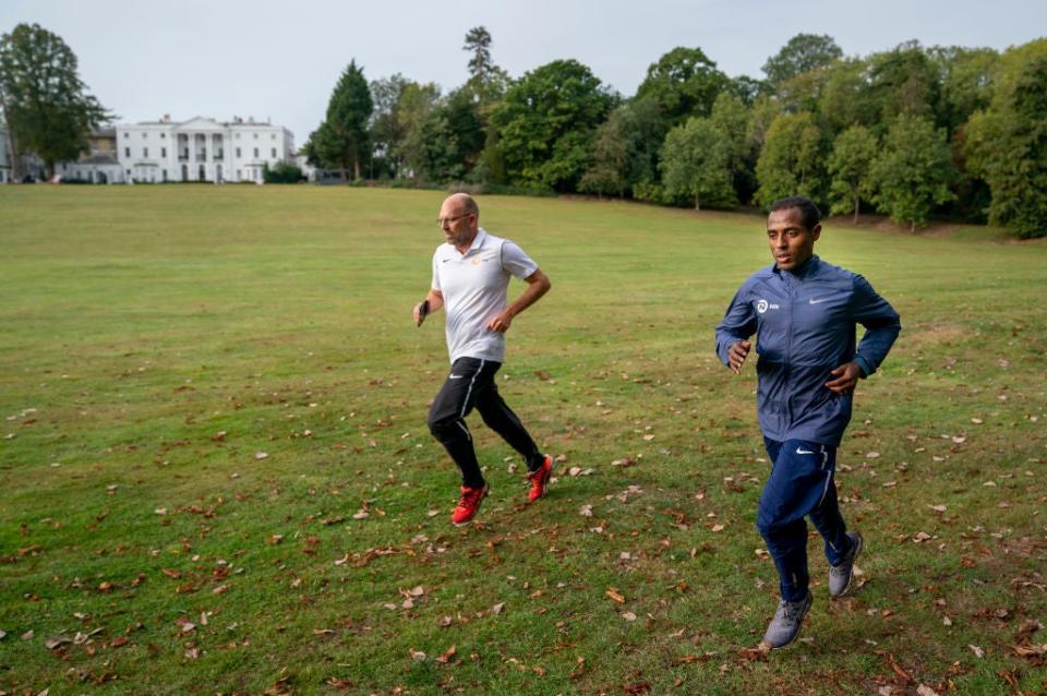 Kenenisa Bekele trains alongside his coach Peter Eemers within the grounds of the bubbleGetty