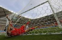 Switzerland's Ricardo Rodriguez falls into the goal net after making a save during their 2014 World Cup Group E soccer match against Honduras at the Amazonia arena in Manaus June 25, 2014. REUTERS/Michael Dalder (BRAZIL - Tags: SOCCER SPORT WORLD CUP TPX IMAGES OF THE DAY)