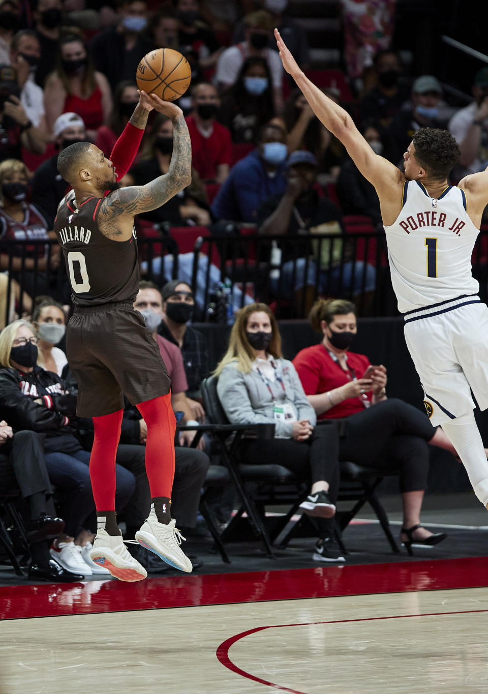 Portland Trail Blazers guard Damian Lillard shoots a 3-point basket over Denver Nuggets forward Michael Porter Jr. during the first half of Game 6 of an NBA basketball first-round playoff series Thursday, June 3, 2021, in Portland, Ore. (AP Photo/Craig Mitchelldyer)