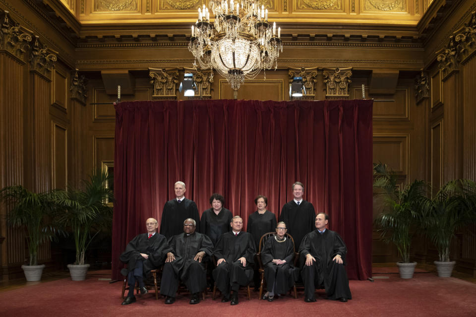 FILE - In this Nov. 30, 2018, file photo, the justices of the U.S. Supreme Court gather for a formal group portrait to include a new Associate Justice, top row, far right, at the Supreme Court Building in Washington. Seated from left: Associate Justice Stephen Breyer, Associate Justice Clarence Thomas, Chief Justice of the United States John G. Roberts, Associate Justice Ruth Bader Ginsburg and Associate Justice Samuel Alito Jr. Standing behind from left: Associate Justice Neil Gorsuch, Associate Justice Sonia Sotomayor, Associate Justice Elena Kagan and Associate Justice Brett M. Kavanaugh. (AP Photo/J. Scott Applewhite, File)