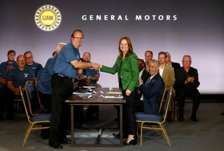 General Motors Chairman and CEO Mary Barra shakes hands with United Auto Workers President Gary Jones at the start of contract talks between the union and automaker in Detroit,