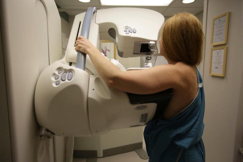 In this May 22, 2015 photo, a woman gets a mammogram at the University of Michigan Cancer Center in Ann Arbor, Mich.  Two large studies, published Wednesday, Jan. 20, 2021, by the New England Journal of Medicine, give a much sharper picture of which inherited mutations raise the risk of breast cancer for women without a family history of the disease, and how common these flawed genes are in the general population. Doctors say the results can help women make better decisions about screening, preventive surgery or other steps. 