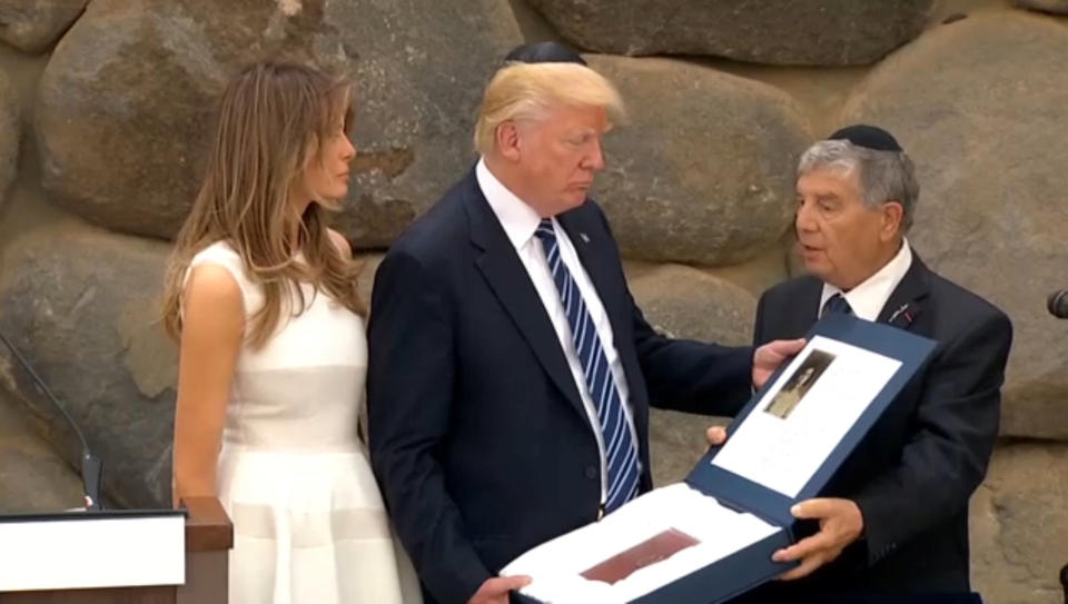 A still image taken from video shows Yad Vashem Chairman Avner Shalev presenting to U.S. President Donald Trump and first lady Melania a token of remembrance, an exact replica of the original Holocaust-era personal album that belonged to Ester Goldstein, who perished in the Holocaust, at Yad Vashem Holocaust memorial in Jerusalem May 23, 2017. (Photo: Reuters Staff / Reuters)