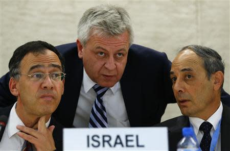 Remigiusz Achilles Henczel (C) President of the Human Rights Council speaks with Eviatar Manor (R) Israel Ambassador to the U.N. and Shai Nitzan (L) Deputy Attorney General Ministry of Justice of Israel before the Human Rights Council Universal Periodic Review session at the European headquarters of the United Nations in Geneva October 29, 2013. REUTERS/Denis Balibouse