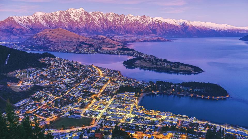 aerial view of queenstown at dusk with lake wakatipu and the remarkables, new zealand