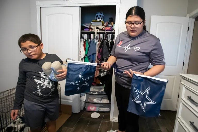 Karina pulls Cowboy flags that belonged to her father from her closet, explaining that the flags will be incorporated in her upcoming quinceañera celebration. She used to watch Cowboy games with her dad and has remained a fan as a way of staying connected to him.