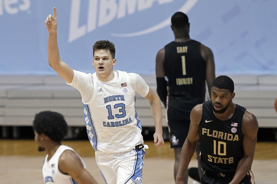 North Carolina forward Walker Kessler (13) reacts following a dunk against Florida State during the second half of an NCAA college basketball game in Chapel Hill, N.C., Saturday, Feb. 27, 2021. Florida State forward Malik Osborne (10) runs at right. (AP Photo/Gerry Broome)