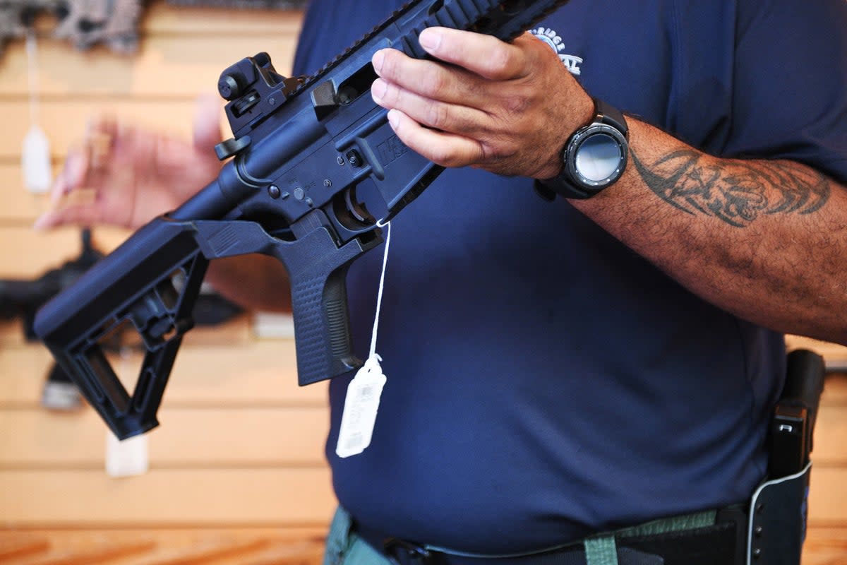A gun salesman demonstrates a bump stock on an AR-style rifle in Virgina. On June 14, the US Supreme Court reversed a federal ban on the devices. (AFP via Getty Images)