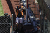 San Francisco Giants catcher Buster Posey, top, talks with manager Gabe Kapler, bottom right, during a baseball practice in San Francisco, Sunday, July 5, 2020. (AP Photo/Jeff Chiu)