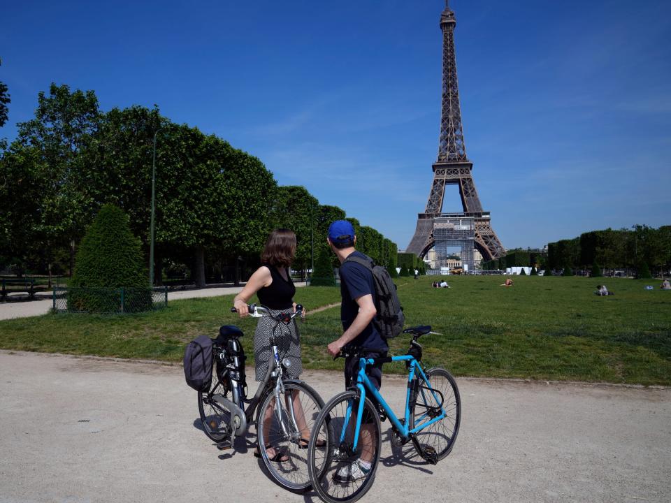 Cyclists take a look at the Eiffel Tower in Paris, Wednesday, June 9, 2021.