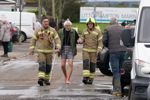 Firefighters help an elderly resident near Rope Walk in Littlehampton