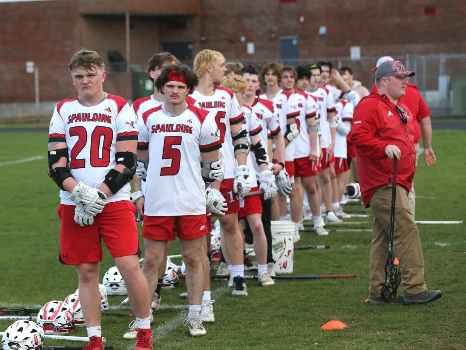 The Spaulding High School boys lacrosse team line before the start of last Wednesday's Division II game against Hollis-Brookline. The Red Raiders broke a 62-game losing streak last Tuesday, an 8-7 overtime win at Pembroke.