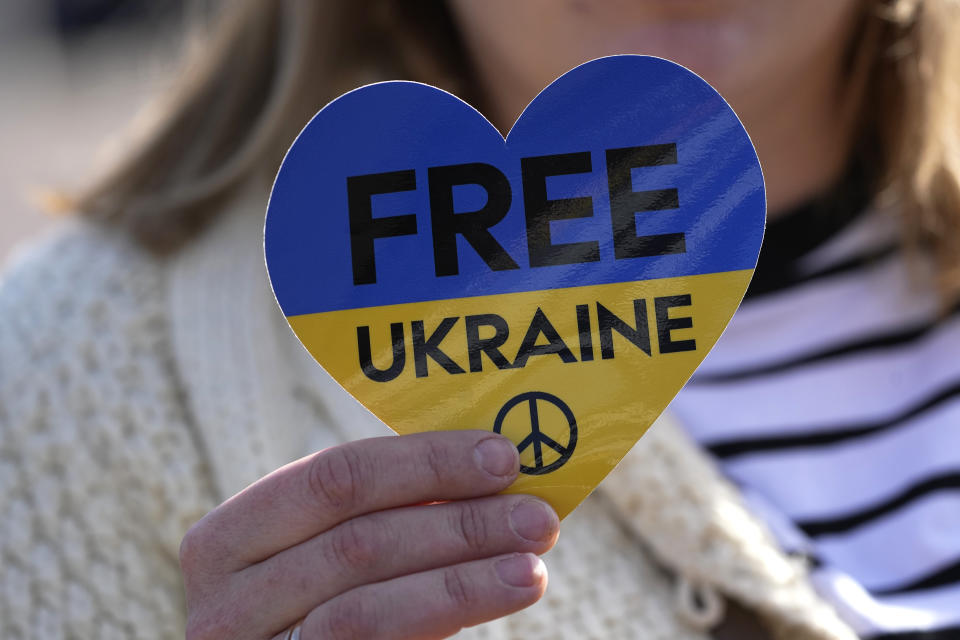 A Ukrainian protester holds a placard during a demonstration near the Chateau de Versailles, where a European Union summit will take place, Thursday, March 10, 2022 in Versailles, west of Paris. With European nations united in backing Ukraine's resistance with unprecedented economic sanctions, three main topics now dominate the agenda: Ukraine's application for fast-track EU membership; how to wean the bloc off its Russian energy dependency; and bolstering the region's defense capabilities. (AP Photo/Michel Euler)