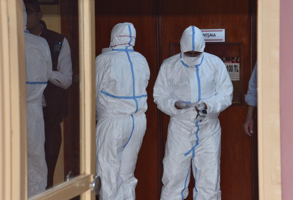 In this photo taken on late Wednesday, April 5, 2017 and made available Thursday, April 6, World Health Organization experts work as they take part in an autopsy conducted in a hospital in Adana, Turkey. Turkey's Justice Minister Bekir Bozdag said autopsy results show Syrians were subjected to chemical weapons attack in Idlib, Syria, on Tuesday. (DHA-Depo Photos via AP)