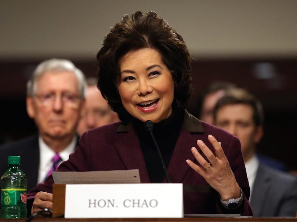 Elaine Chao speaks in Congress, with Mitch McConnell visible in the background