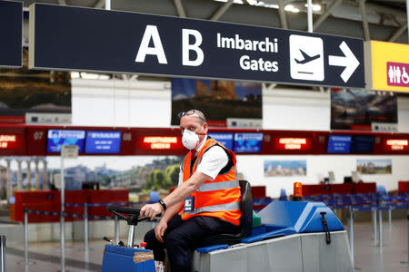 A man wears a mask after Ciampino Airport in Rome, Italy was evacuated due to a fire, February 19, 2019. REUTERS/Yara Nardi