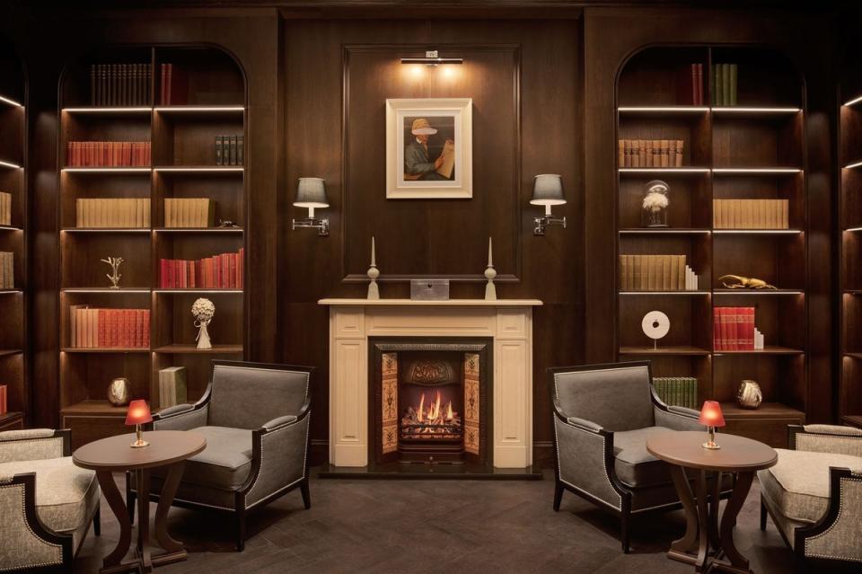 Take a seat by the fire in the Library Club at Fairmont Windsor Park (Fairmont Windsor Park)