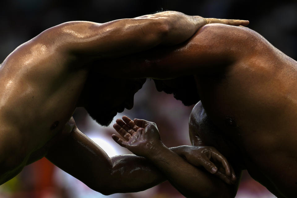 Wrestlers compete during the 663rd annual Historic Kirkpinar Oil Wrestling championship, in Edirne, northwestern Turkey, Saturday, July 6, 2024. Wrestlers take part in this "sudden death"-style traditional competition wearing only a pair of leather trousers and a good slick of olive oil. The festival is part of UNESCO's List of Intangible Cultural Heritages. (AP Photo/Khalil Hamra)