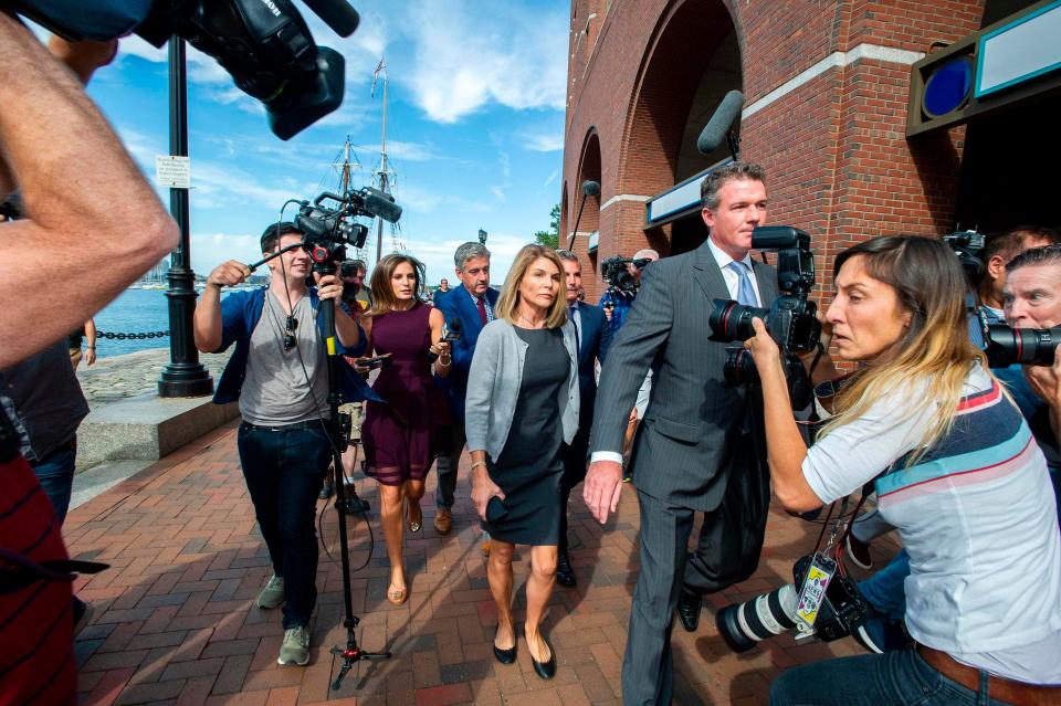 Lori Loughlin and husband Mossimo Giannulli exit the Boston Federal Court house after a pre-trial hearing with Magistrate Judge Kelley at the John Joseph Moakley US Courthouse in Boston on August 27, 2019. Loughlin and Giannulli are charged with conspiracy to commit mail and wire fraud and conspiracy to commit money laundering in the college admissions scandal. The Loughlins later pleaded not guilty to the charges. 