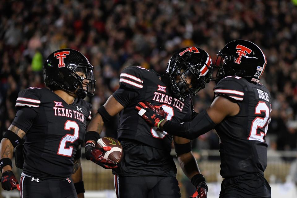 Texas Tech cornerback Rayshad Williams, center, celebrates his fumble recovery against Baylor with safety Reggie Pearson (2) and cornerback Malik Dunlap, right. Williams and Dunlap will return to the Red Raiders in 2023 on the Covid-bonus year granted by the NCAA, defensive coordinator Tim DeRuyter said, and Pearson is exploring his options as a graduate transfer.