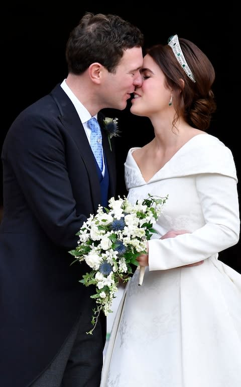 Britain's Princess Eugenie and Jack Brooksbank kiss - Credit: Toby Melville, Pool via AP