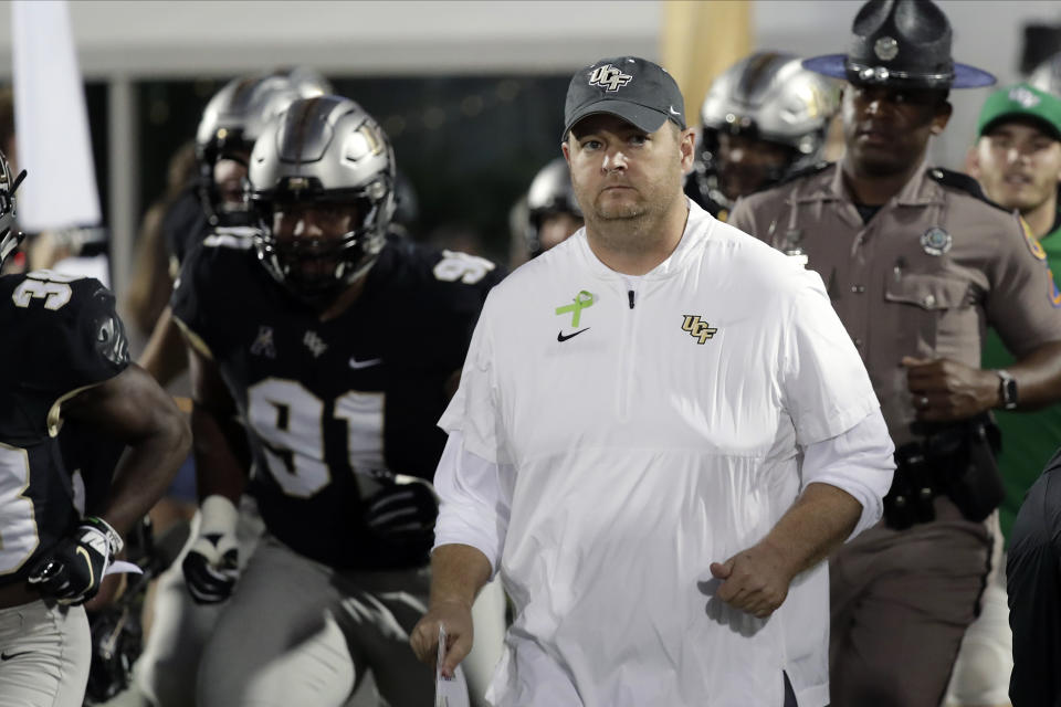 Central Florida head coach Josh Heupel takes the field with his players before the first half of an NCAA college football game against East Carolina, Saturday, Oct. 19, 2019, in Orlando, Fla. (AP Photo/John Raoux)