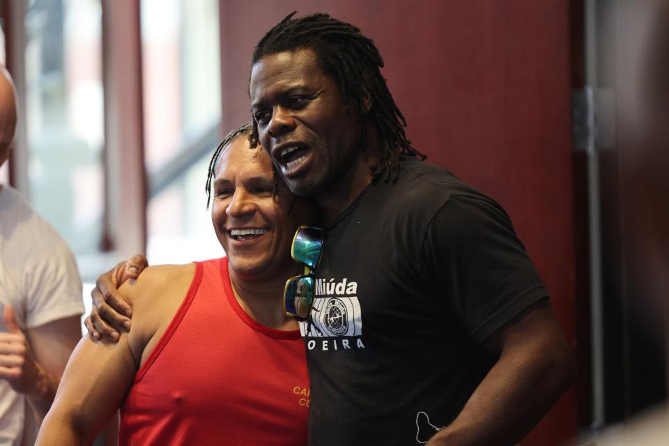 Mestre Jamaika hugs Sandro do Nascimento during capoeira classes at Trolley Square in Salt Lake City on April 28. 