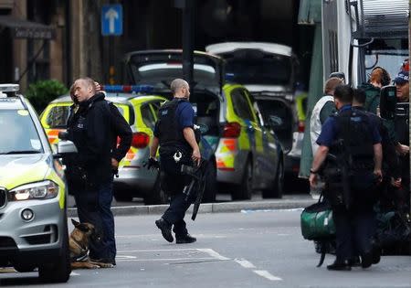 Armed police stand outside Borough Market after an attack left 6 people dead and dozens injured in London, Britain, June 4, 2017. REUTERS/Peter Nicholls
