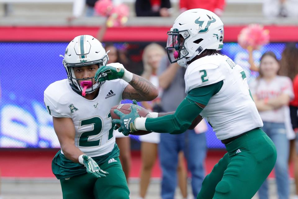 South Florida running back Brian Battie (21) takes a hand off from running back Michel Dukes (2) on a trick play against Houston during the first half of an NCAA college football game Saturday, Oct. 29, 2022, in Houston. (AP Photo/Michael Wyke)