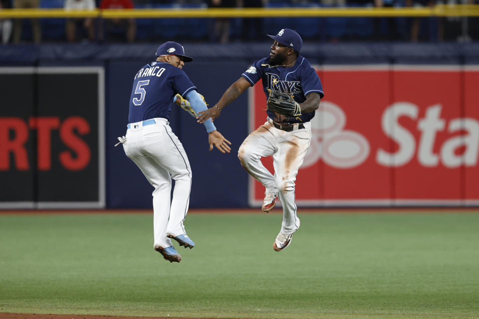 Tampa Bay Rays' Wander Franco, left, and Randy Arozarena celebrate after the Rays defeated the Boston Red Sox in a baseball game Tuesday, April 11, 2023, in St. Petersburg, Fla. (AP Photo/Scott Audette)